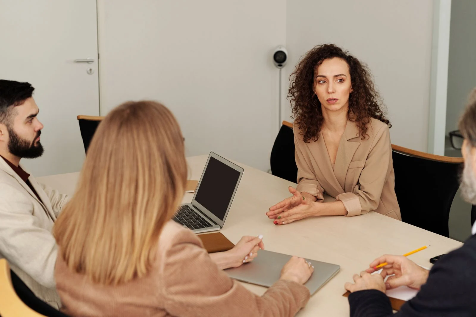 Professionals discussing national talent recruitment in an office